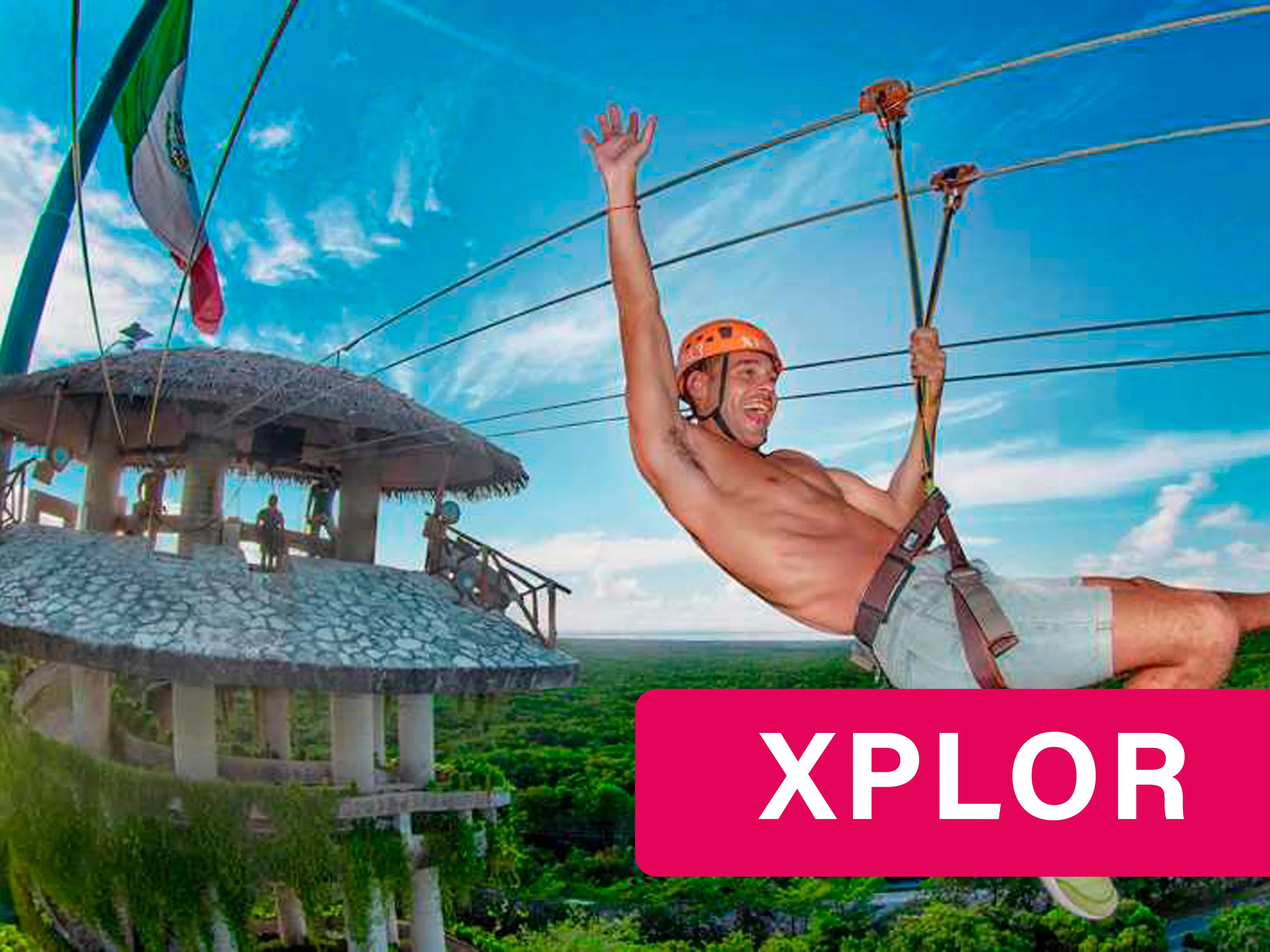 Man on a zipline with the Mexican flag on the back at Xplore Adventure Park